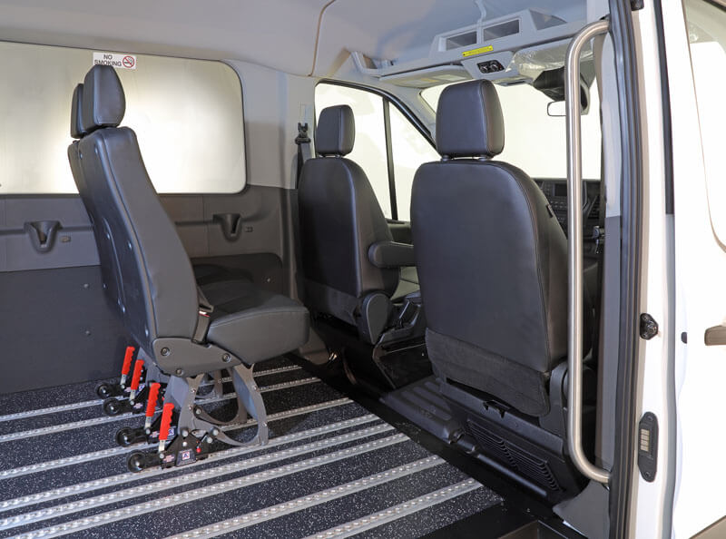 Ford Transit interior with wheelchair tie-down tracks and seating — ADA conversion
